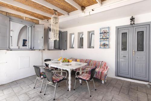 a kitchen and dining room with a table and chairs at Villa Kleanthi in Lardos