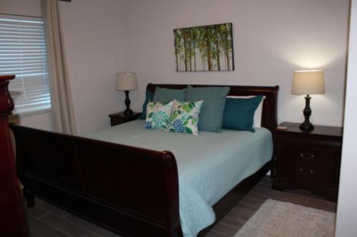 a bedroom with a large bed with blue pillows at Sanibel 406 by ALBVR - Beautiful updates with views that are simply amazing in Gulf Shores