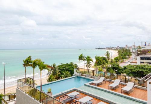 a view of the beach from the balcony of a building at Arpoar Suítes by Slaviero Hotéis in João Pessoa