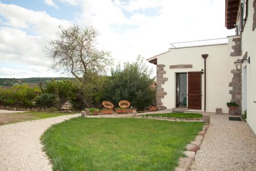 a house with a green lawn in front of it at Artemisia Sardegna in Tergu
