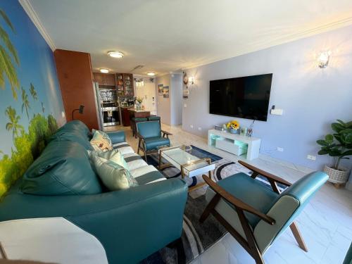 a living room with a couch and chairs and a tv at Amazing waikiki Beach condo 2Bed2Bath+free Parking in Honolulu
