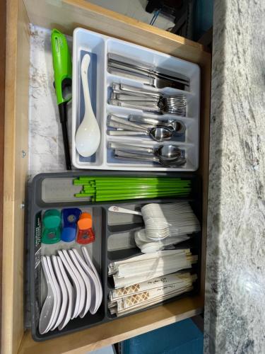 a drawer filled with dishes and utensils at Amazing waikiki Beach condo 2Bed2Bath+free Parking in Honolulu