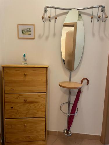 a dressing room with a mirror and a dresser at Kis-Celli apartman in Budapest