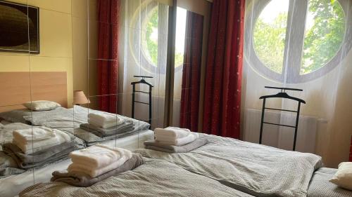 a bedroom with two beds with towels on them at Kis-Celli apartman in Budapest