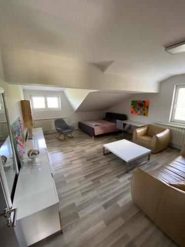a living room with a couch and a table at Vila Sunset Jugovo in Udovice