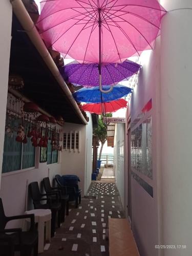 a corridor with umbrellas hanging from the ceiling at Cabanas Recreaciones in Coveñas