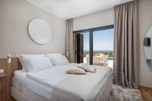 a bedroom with a bed with a view of the ocean at Villa Axel in Primošten