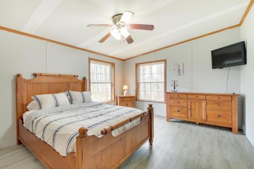 a bedroom with a bed and a ceiling fan at Cozy Midcoast Vacation Rental Near Waterville! 