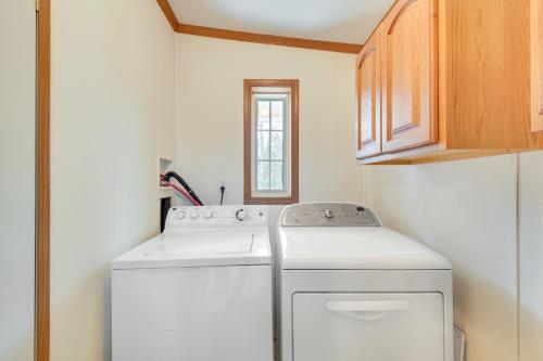 a small laundry room with a washer and dryer at Near Waterville Cozy Midcoast Vacation Rental! in Albion