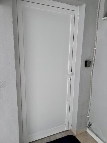 a white door in a room with at Perdja Apartment I in Velipojë