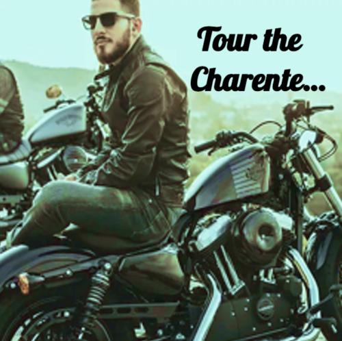 a man sitting on top of a motorcycle at Linden Lodge Stays in Saint-Claud