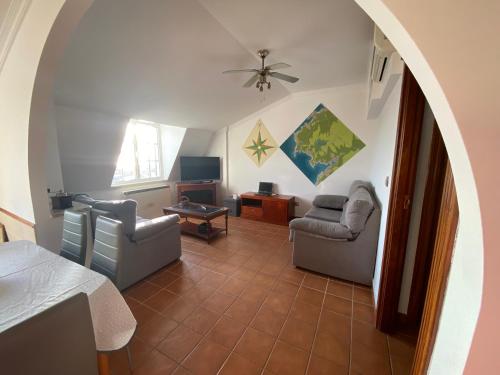 a living room with two chairs and a table at CASA Beirada Monte y Playa in Carnota