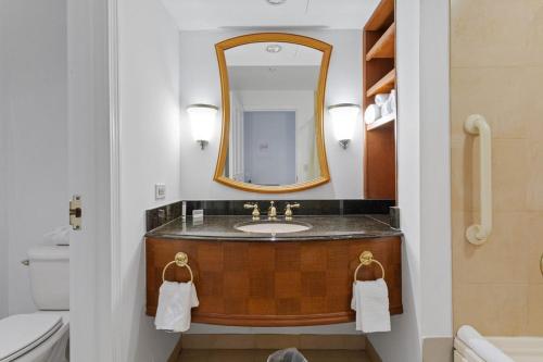 a bathroom with a sink and a mirror at Beachfront Double Queen - CozySuites in Atlantic City