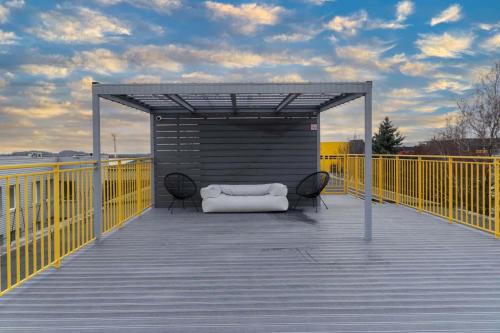 a white couch sitting on a deck with awning at Air Apartment 104 in Vilnius