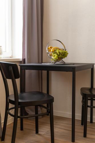 a black table with a basket of fruit on it at Air Apartment 104 in Vilnius