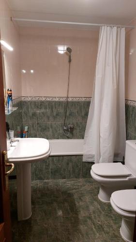 a bathroom with a sink and a toilet and a shower at sweethome el cerro in Rasines
