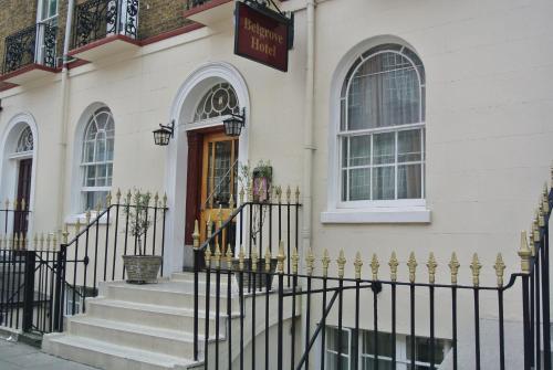 a black fence in front of a white building at The Belgrove Hotel in London