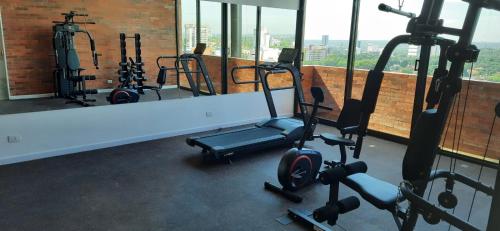 a gym with several exercise bikes in a room with windows at Edificio Flats del sol in Asuncion