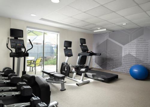a gym with several treadmills and exercise bikes at SpringHill Suites Kansas City Overland Park in Overland Park