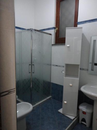 a bathroom with a glass shower and a sink at B&B Nola in Nola
