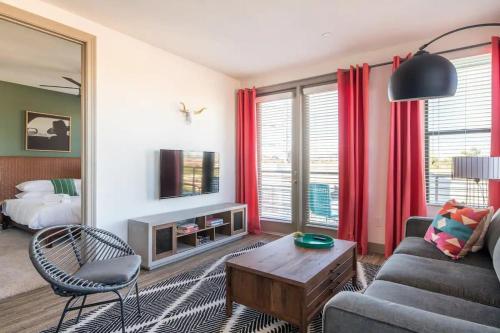 a living room with a couch and a table at Modern Town Lake waterfront CozySuites in paradise in Tempe
