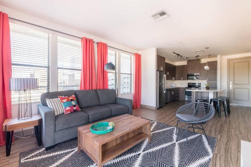 a living room with a couch and a table at Modern Town Lake waterfront CozySuites in paradise in Tempe