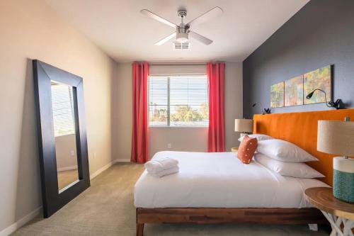 a bedroom with a large white bed and a window at Modern CozySuites - paradise under the palm trees! in Phoenix