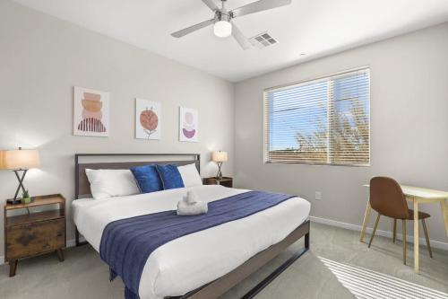 a bedroom with a large bed with a blue blanket at Paradise Cozysuites Under the Palms with jacuzzi 18 in Phoenix