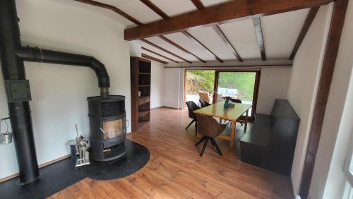 a living room with a wood stove and a table at Maal Waldhaus in Todtnau