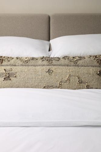 um close-up de uma cama com lençóis brancos e almofadas em Górski Domek Zakopane em Kościelisko