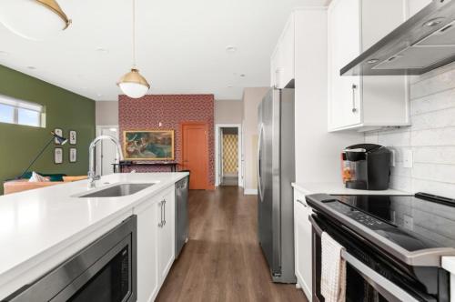 a kitchen with a sink and a refrigerator at Mason Lofts at West End in Nashville