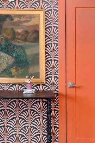 a painting on a wall with a table next to a door at Mason Lofts at West End in Nashville