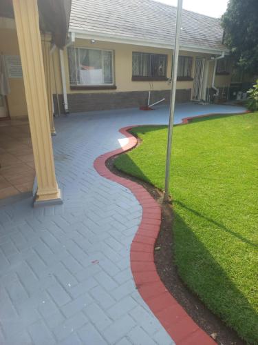 a red brick walkway in front of a house at 26 Zea avenue Arcon Park Guest House in Vereeniging