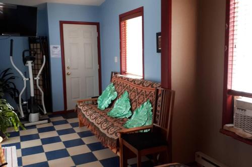a blue room with a bench with a pillow on it at Luisa's guest suite in Keremeos