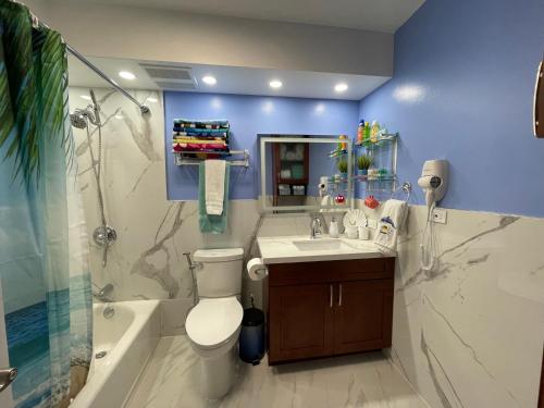 a bathroom with a toilet and a sink and a shower at Amazing waikiki Beach condo 2Bed2Bath+free Parking in Honolulu