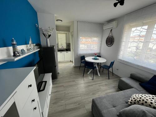 a living room with a couch and a table at Apartman Valor in Rovinj