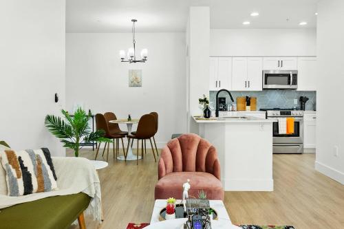 a living room with a couch and a table at CozySuites Glendale by the stadium w pool 07 in Glendale