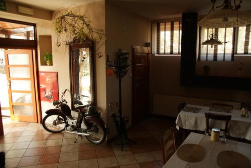 a motorcycle parked in a room with a table at Willa Wiosna in Września
