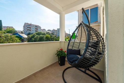 einen Schaukelstuhl auf einem Balkon mit Fenster in der Unterkunft Apartment Kate with FREE PARKING in Dubrovnik