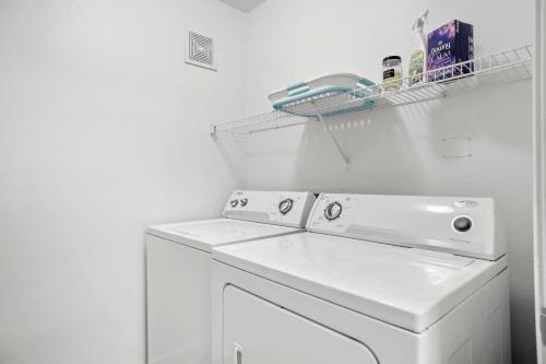 a white washer and dryer in a white laundry room at CozySuites Modern Urban in Historic Glendale in Glendale