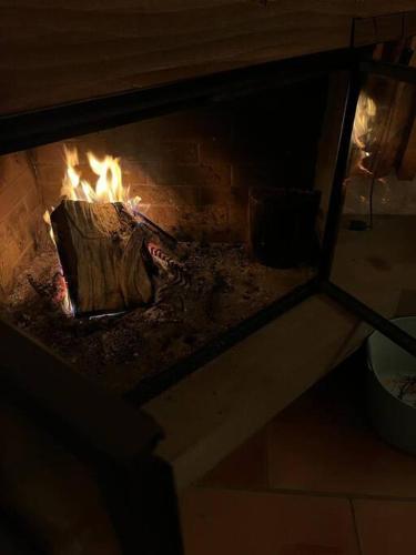 a brick oven with a fire in it at Boutique B21 in Unterseen