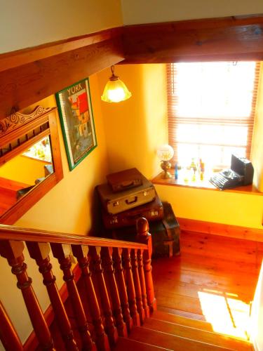 a room with a staircase with luggage and a window at Riverside Bed & Breakfast in Bainbridge
