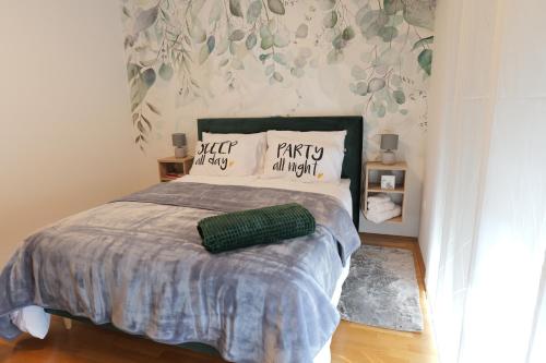 a bedroom with a bed with two pillows on it at Apartman Tina ***** s jacuzzijem u blizini Parka prirode Papuk in Szlatina