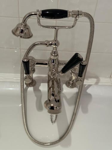 a bathroom sink with a hair dryer and a faucet at Greenhill Farm Barn B&B in Sutton under Brailes
