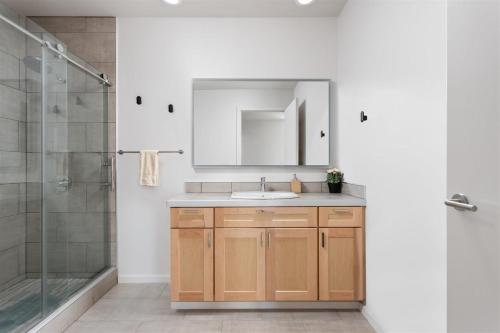 a bathroom with a sink and a shower at Modern Penthouse on Mass By CozySuites in Indianapolis