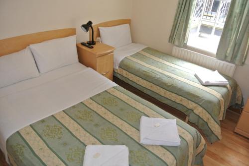 Postel nebo postele na pokoji v ubytování The Belgrove Hotel