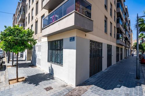 a building with a balcony on the side of a street at Exquisite studio apartment with an original design in Valencia