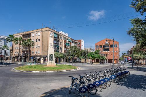 a row of bikes parked on a city street at Exquisite studio apartment with an original design in Valencia