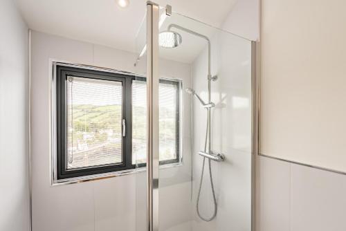 a bathroom with a shower and a window at Beach View in Ilfracombe