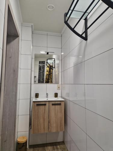 a bathroom with a sink and a mirror at le coin douillet in Saint-Ghislain